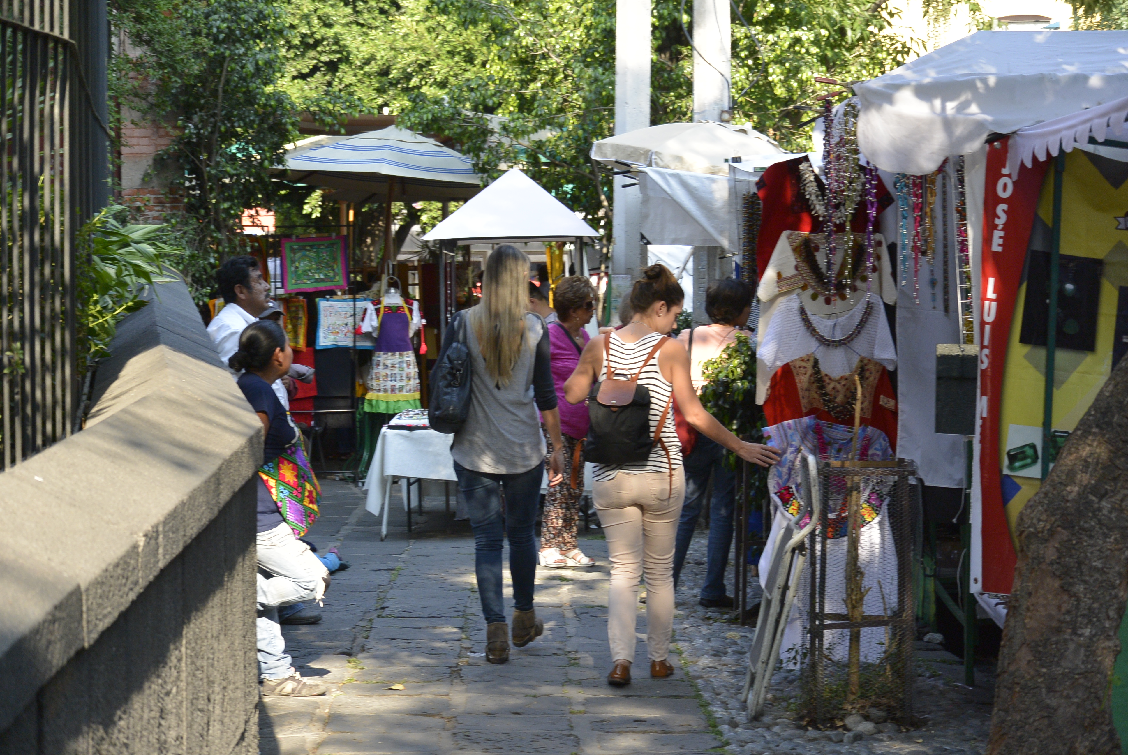 Visitors browse the San Ángel art market in Mexico City, where local artists gather to sell their work.