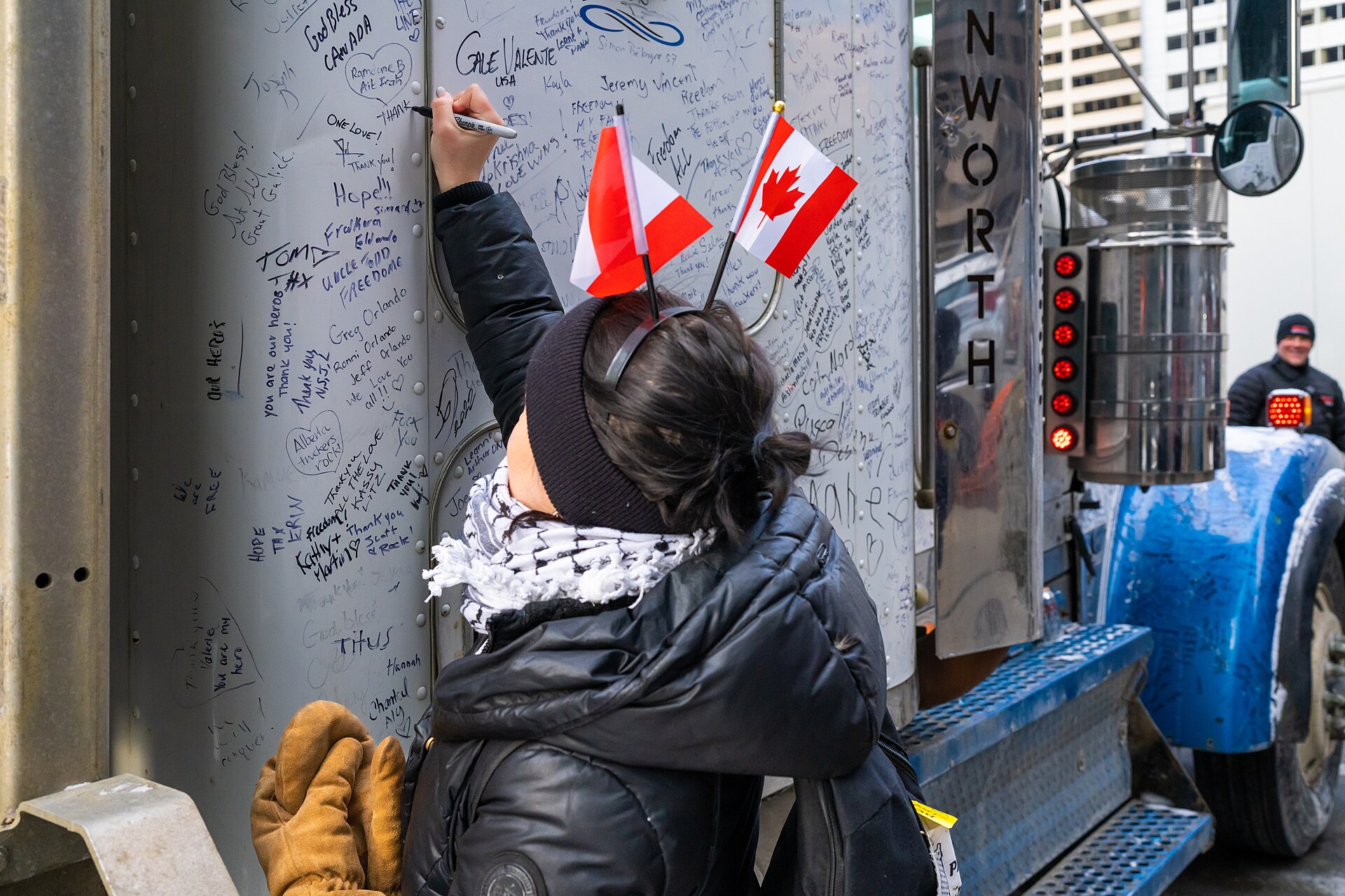 A protester writes a message on a truck during the Freedom Convoy protest in Ottawa, Canada, February 2022.